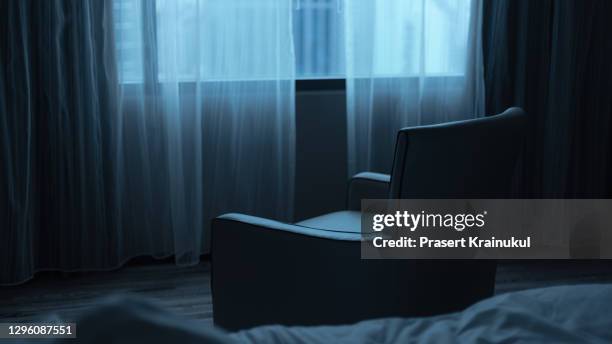 empty armchair with window in the room, night time. - stay indoors stock pictures, royalty-free photos & images