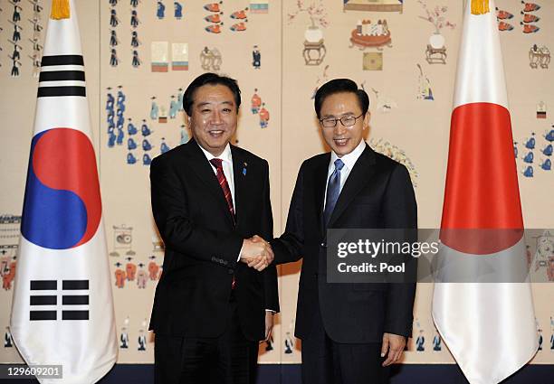 South Korean President Lee Myung-Bak shakes hands with Japanese Prime Minister Yoshihiko Noda during their meeting at the Presidential House on...