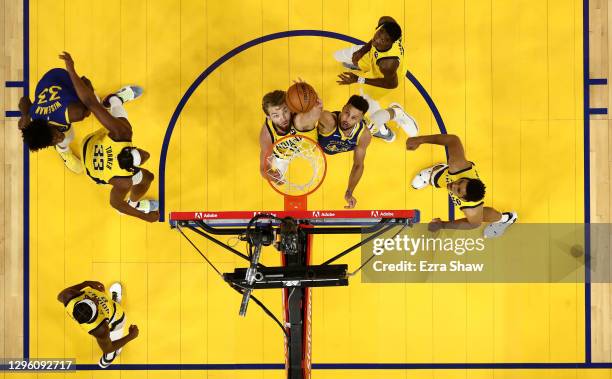 Stephen Curry of the Golden State Warriors and Domantas Sabonis of the Indiana Pacers go for a rebound at Chase Center on January 12, 2021 in San...