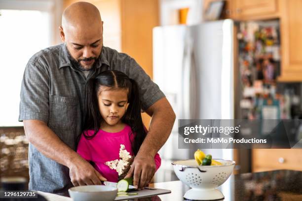 father and daughter cooking in kitchen - leanincollection stock pictures, royalty-free photos & images