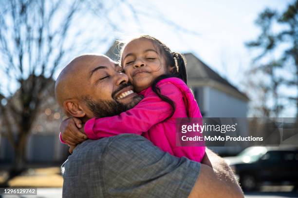 father holding young daughter outdoors - kids hug ストックフォトと画像