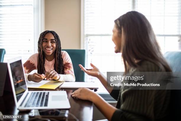 teenage girls studying at home - facial expression girl office stock-fotos und bilder