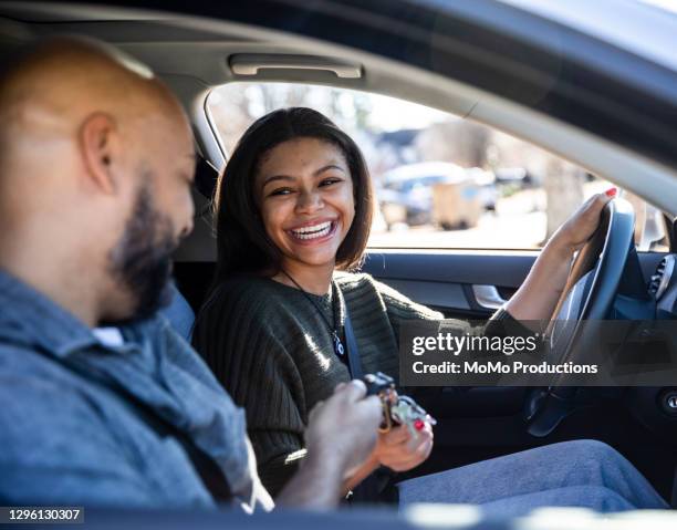 father handing car keys to teenage daughter - daughter car stock pictures, royalty-free photos & images