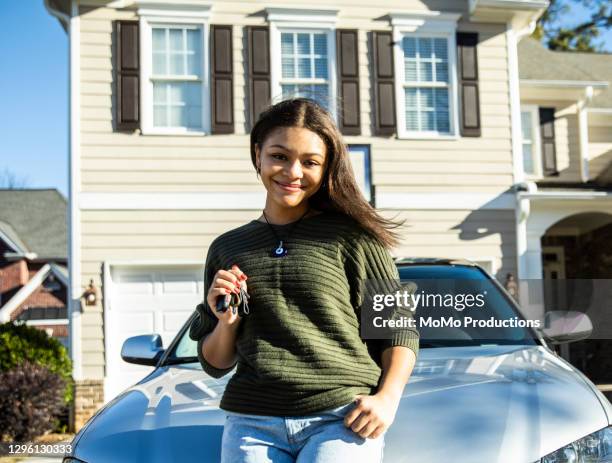 portrait of teenage girl with her first car - automotive trend stock pictures, royalty-free photos & images