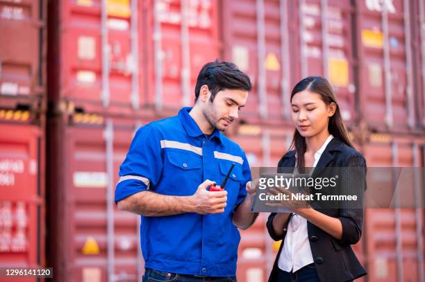 customs officers are working on large cargo container terminal yard while inspecting cargo on entry by customs mobile app. import and export business process.  logistic transportation business concepts. - government employee stock pictures, royalty-free photos & images