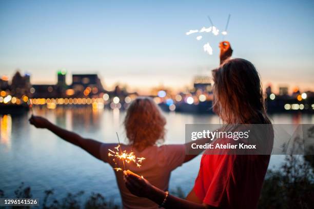 dancing with sparklers in the evening celebrating summer and having a free spirt - montreal city stockfoto's en -beelden