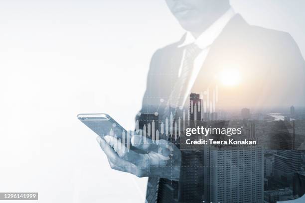 the double exposure image of the business man using a smartphone and wireless network - man double exposure profit concept stock pictures, royalty-free photos & images