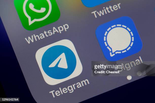 In this photo illustration, the logos of social media applications WhatsApp, Twitter, Telegram and Signal are displayed on the screen of an iPhone on...