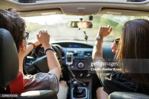 friends dancing while on a road trip during beautiful summer day - zomer muziek stockfoto's en -beelden