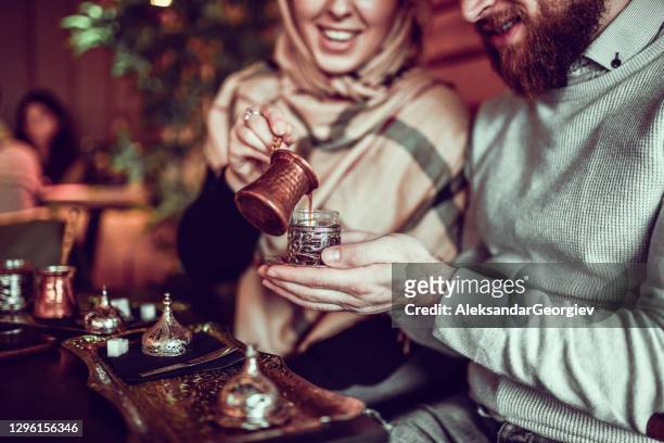 cute muslim couple enjoying coffee time - turkish coffee drink stock pictures, royalty-free photos & images