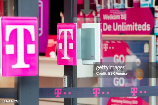 View of a T-Mobile logo at a storefront on January 13, 2021 in Dordrecht, Netherlands. Newspaper Het Financieele Dagblad reports that Deutsche...