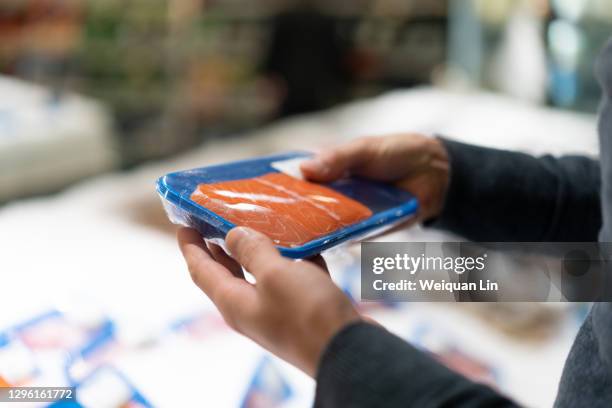 the person picking salmon - viswinkel stockfoto's en -beelden