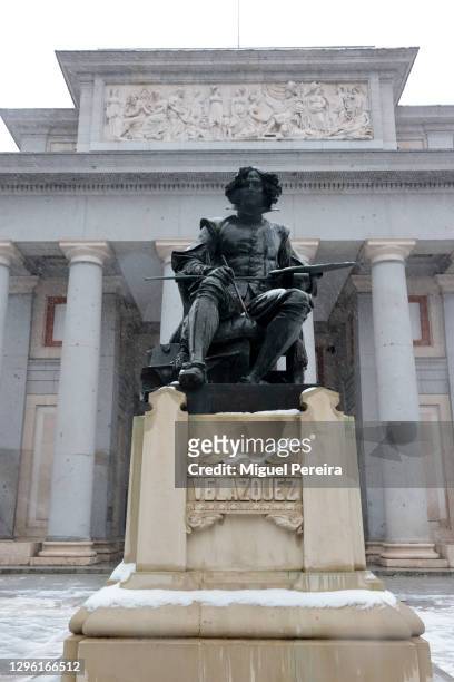 The statue of famous Spanish painter Diego Velázquez stands in front of El Prado Museum under a heavy snowfall as storm Filomena hits the city on...