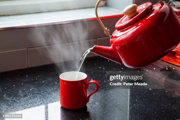 making tea - pouring boiling water into a mug - boiling kettle stock pictures, royalty-free photos & images