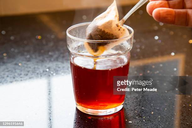 taking the teabag out of the tea - tea bags stock pictures, royalty-free photos & images