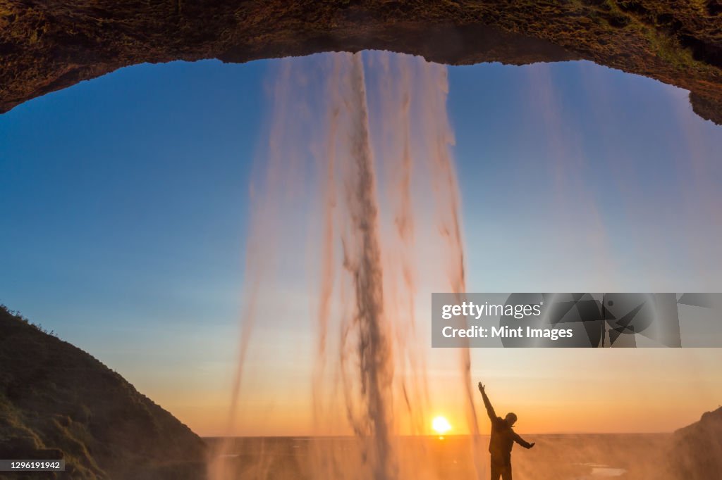 Man behind Seljalandsfoss Waterfall, South Iceland, Iceland