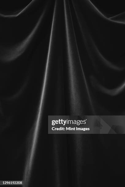 close up of velvet curtain, focus on folds and creases - black curtain stock pictures, royalty-free photos & images