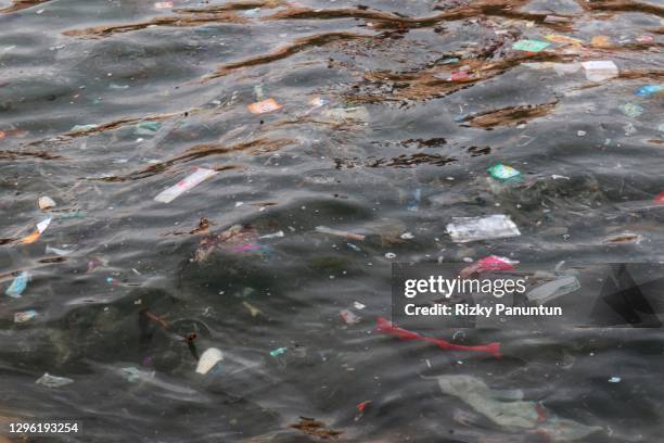 plastic trash floating on sea surface - unhygienic stock pictures, royalty-free photos & images