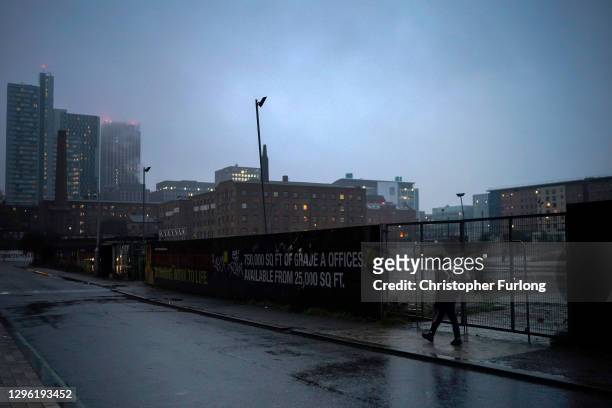Man walks through the near deserted streets of Manchester during lockdown three on January 13, 2021 in Manchester, United Kingdom. On Monday January...