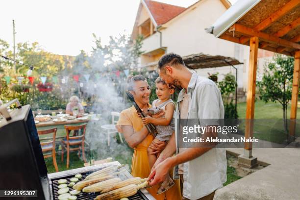 barbecue party in our backyard - barbecue social gathering stock pictures, royalty-free photos & images