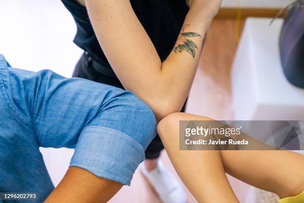 detail of young interracial business team elbows bump as covid-19 alternative handshakes. back at work in new normal modern office after lockdown. new normal concept. - elbow bump stock pictures, royalty-free photos & images