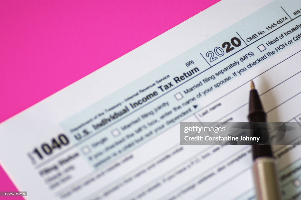 Close Up of Tax Form 1040 For Year 2020 on Pink Background