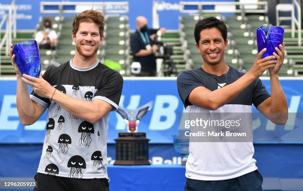 Ariel Behar of Uruguay and Gonzalo Escobar of Ecuador pose with their trophies after winning against brothers Ryan and Christian Harrison during the...