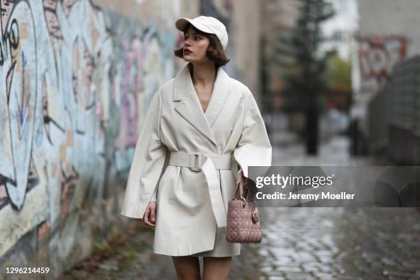 Lea Naumann wearing Nobi Talai coat, Dior bag and can’t decide clothing cap on January 12, 2021 in Berlin, Germany.