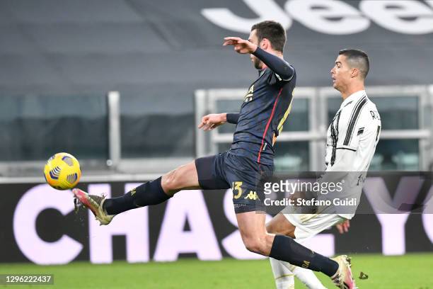 Mattia Bani of Genoa CFC makes a save against Cristiano Ronaldo of Juventus FC during the Coppa Italia match between Juventus and Genoa CFC at...