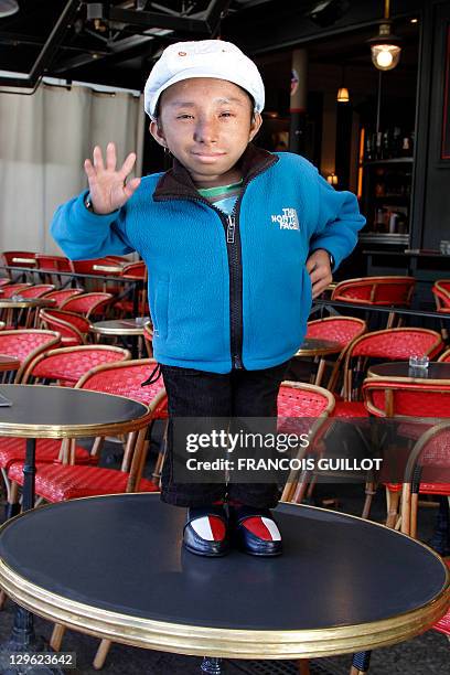 Nepalese Guinness World Record holder Khagendra Thapa Magar the second world's smallest man with 67 cm , poses on a table in a French cafe in Paris...