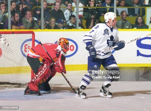 Derek King of the Toronto Maple Leafs skates against Jean-Sebastian Giguere of the Calgary Flames during NHL game action on November 23, 1998 at...
