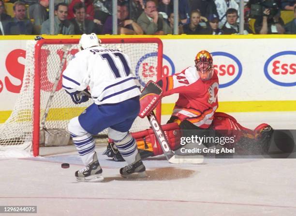 Jean-Sebastien Giguere of the Calgary Flames skates against Steve Sullivan of the Toronto Maple Leafs during NHL game action on November 23, 1998 at...