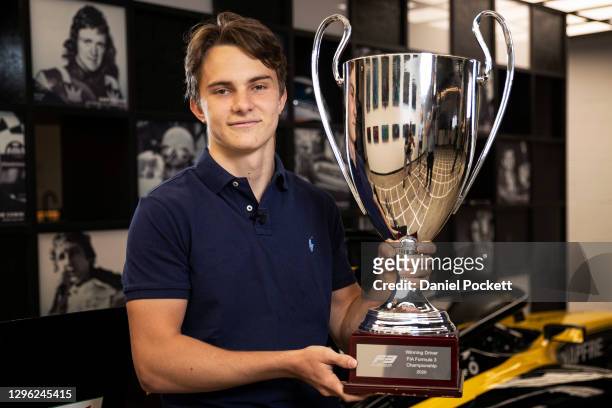 Oscar Piastri poses for a photograph with the 2020 FIA Formula 3 Championship trophy during a media opportunity at Motorsport Australia House on...