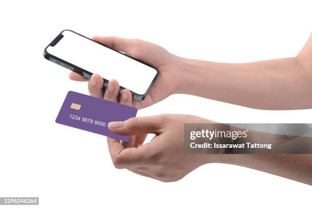 woman's hand hold smartphone and credit card psd mockup - credit card mockup stock pictures, royalty-free photos & images