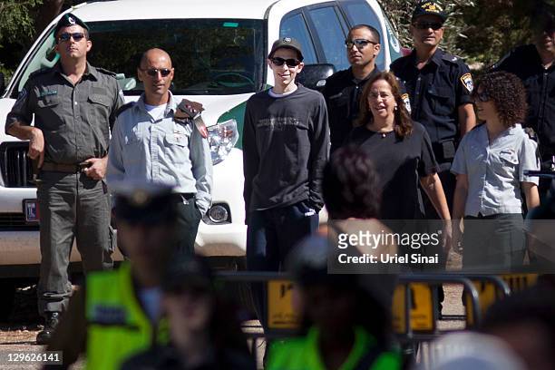 Gilad Shalit walks with his mother Aviva outside their home on October 19, 2011 in Mitzpe Hila, Israel. Shalit was freed yesterday after being held...
