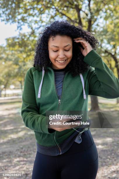 young woman with type-1 diabetes checks blood sugar monitor and insulin pump during outdoor hike - oil pump stock pictures, royalty-free photos & images