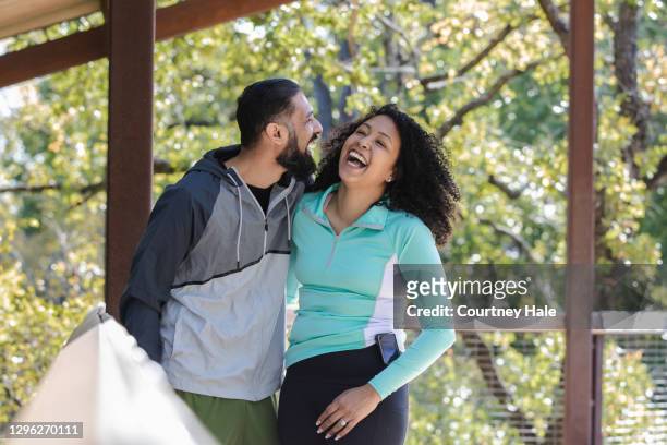 beautiful young woman with type-1 diabetes laughs while spending quality time outdoors with husband - insulin pump stock pictures, royalty-free photos & images