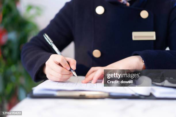 female greet guests  writing - door attendant stock pictures, royalty-free photos & images