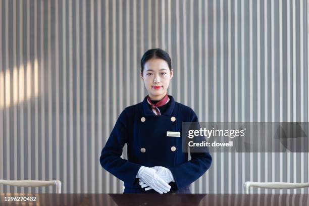 portrait of smiling young receptionist - bellhop stock pictures, royalty-free photos & images