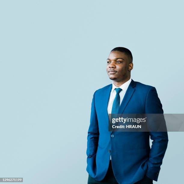 thoughtful male ceo standing with hands in pockets - african male portrait imagens e fotografias de stock