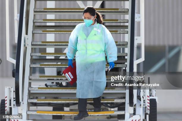 Member of the Australian government biosecurity wearing PPE is seen stepping of chartered flight QR7176 arrives at Melbourne Jet Base adjoining the...