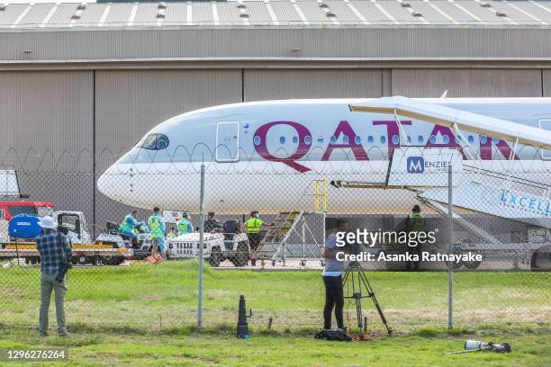 General view of chartered flight QR7176 carrying players and officials participating at the Australian Open is seen surrounded by Airport and Bio...