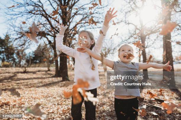 Fall Weather Kids Kids Playing In Fall Leaves Photos and Premium High Res Pictures ...