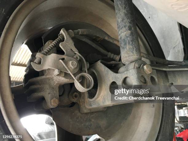 coil spring and sling of the handbrake in the rear wheel of the car - tyre bridge stock pictures, royalty-free photos & images