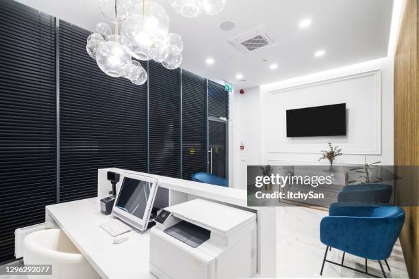 behind the reception desk at a private medical clinic - lobby screen stock pictures, royalty-free photos & images