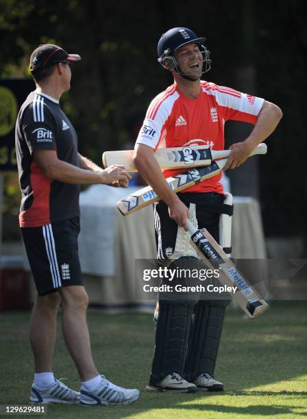 Jonathan Trott of England shares a joke with coach Andy Flower during a nets session at The Punjab Cricket Association Stadium on October 19, 2011 in...