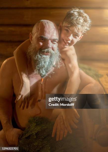 cheerful family (dad and son) resting at bathhouse - young boy in sauna stock pictures, royalty-free photos & images