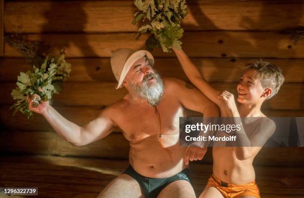 healthy leisure to family. father and son are having fun in sauna - young boy in sauna stock pictures, royalty-free photos & images