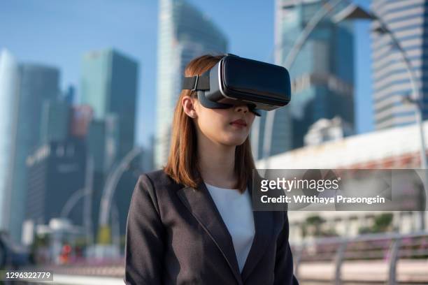 business woman using virtual reality glasses - cat vr stock-fotos und bilder