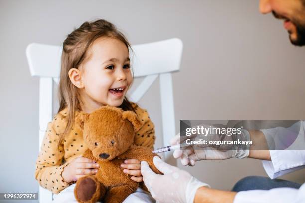 vaccination to a child - teddy bear stock pictures, royalty-free photos & images